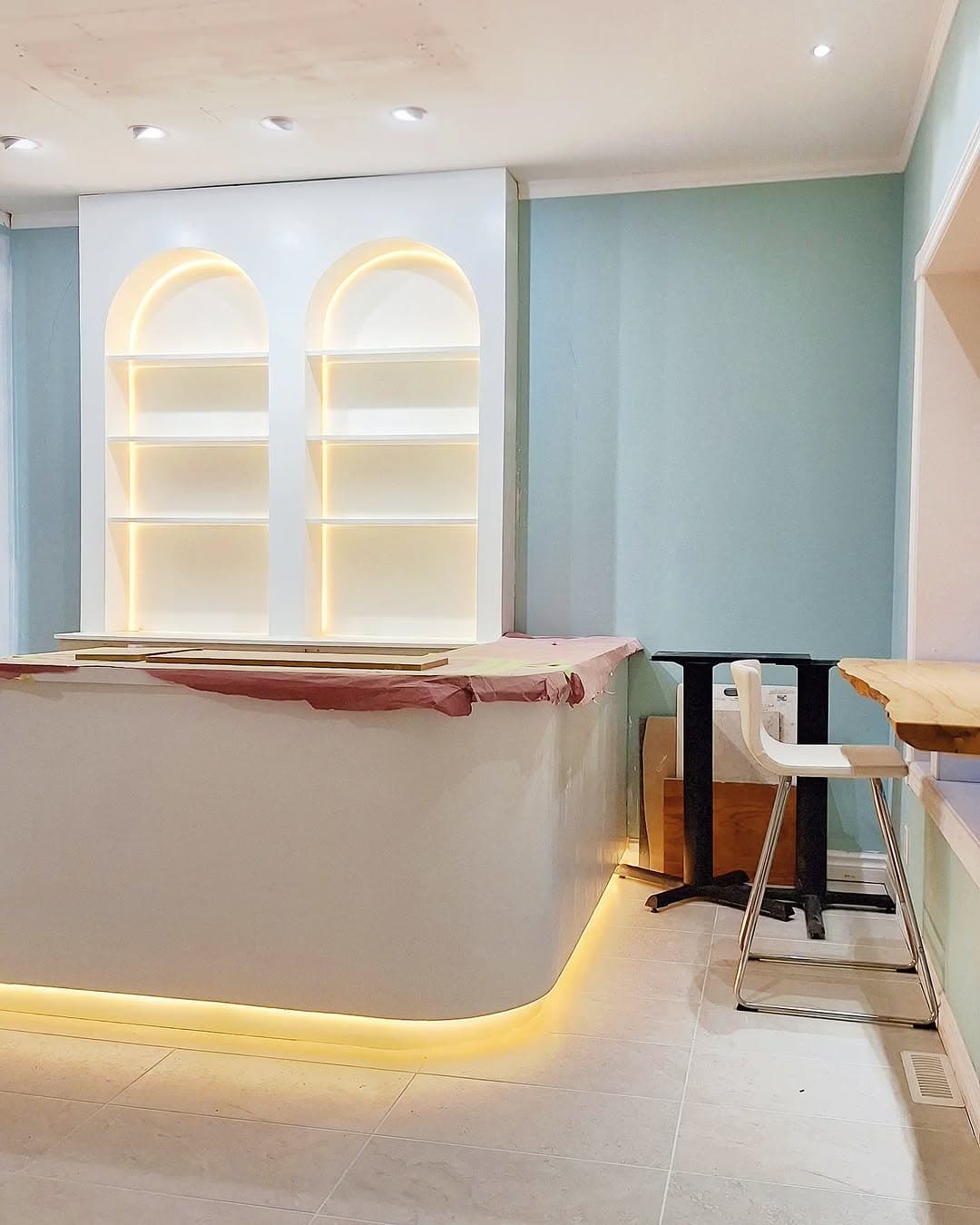 LED-lit arched shelving and bar area